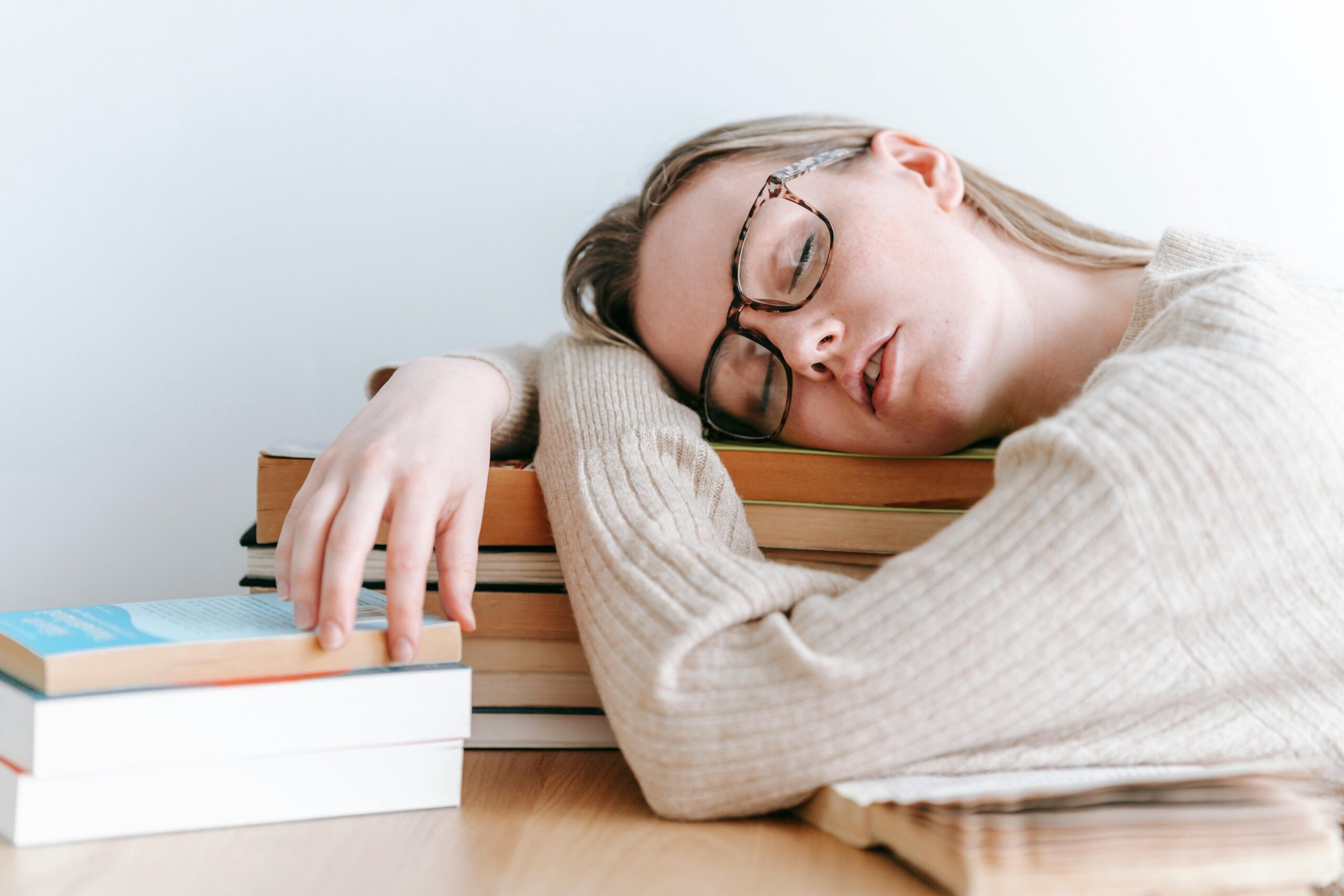 Woman asleep on books